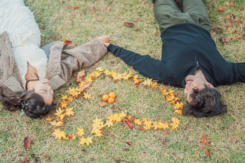 Engagement couple enjoying the vibrant autumn scenery in Arashiyama Kyoto during their photoshoot