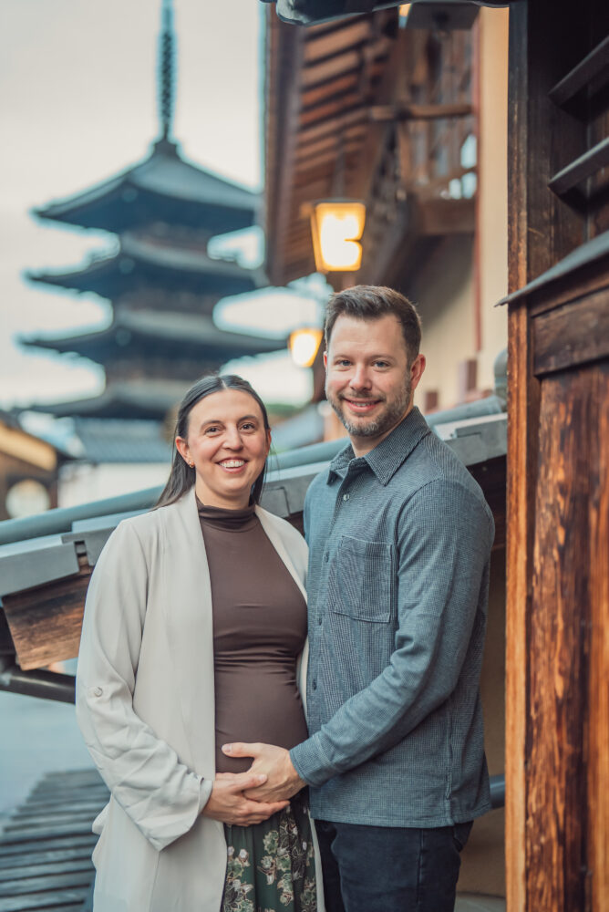 Expecting parents walking through Higashiyama Kyoto with the iconic Yasaka Pagoda in the background
