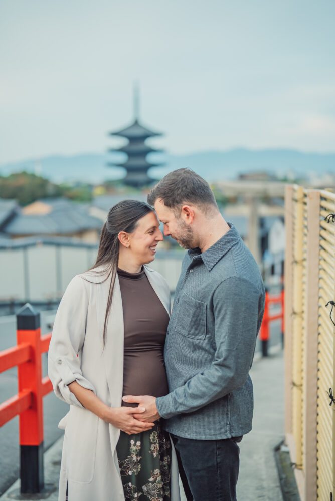 Expecting couple during a maternity photoshoot with Yasaka Pagoda in the background in Higashiyama Kyoto