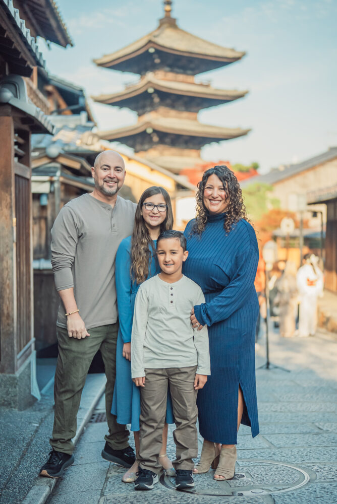 A family standing together with Yasaka Pagoda in the background during a family photoshoot in Kyoto