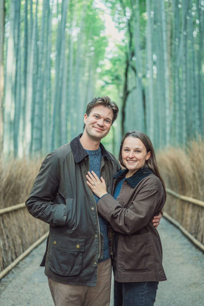 Romantic couple walking through Arashiyama Bamboo Forest in Kyoto during their proposal photoshoot