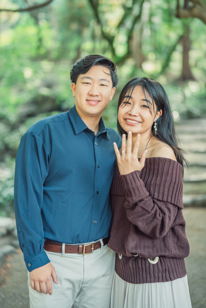 Happy couple celebrating their engagement after a proposal at Maruyama Park in Kyoto Japan