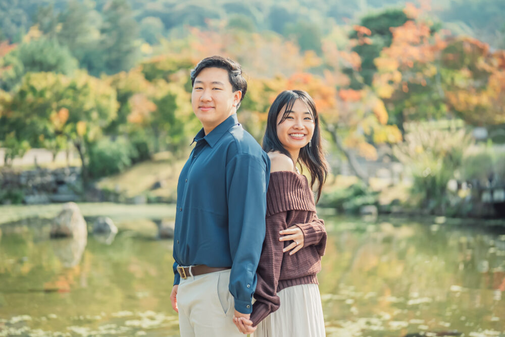 Couple standing together and sharing a romantic moment in a Kyoto park after a proposal