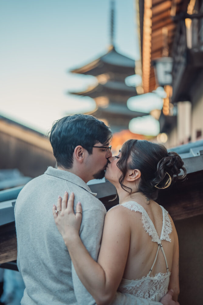 Engaged couple taking romantic photos at sunset with the iconic Yasaka Pagoda in Higashiyama Kyoto in the background