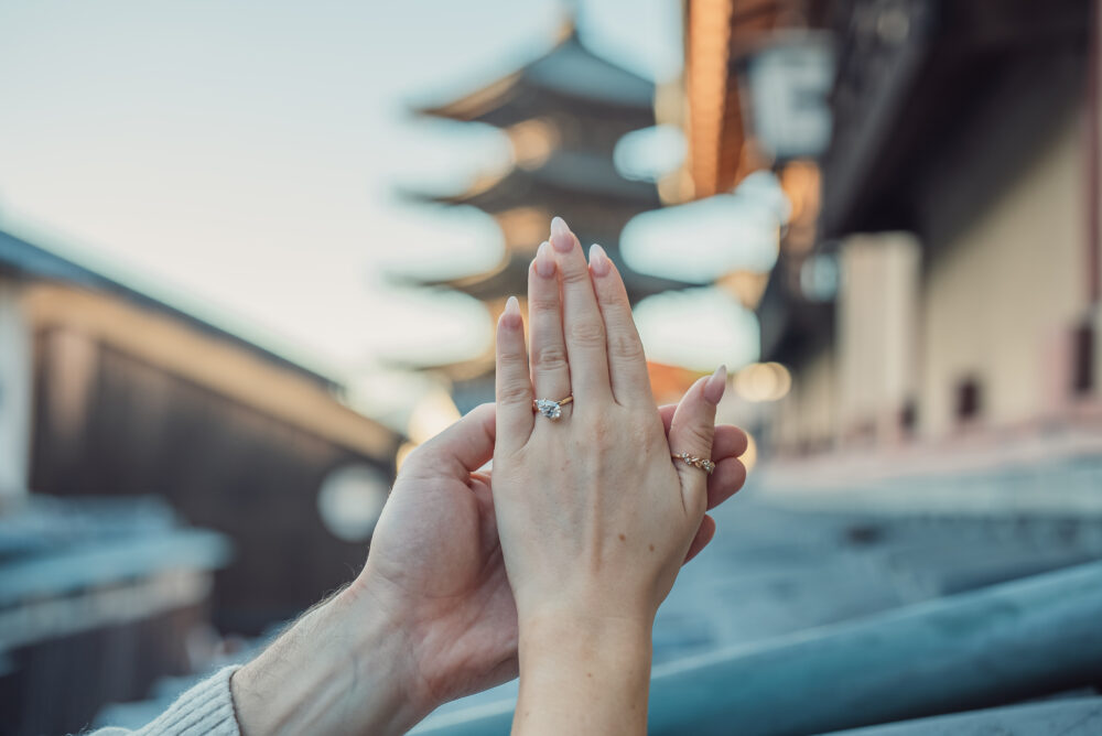 Newly engaged couple celebrating their proposal with a golden hour photoshoot in front of Yasaka Pagoda Kyoto