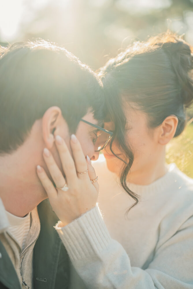 A romantic couple portrait in Kyoto during sunset with soft golden light as they close their eyes and touch foreheads together