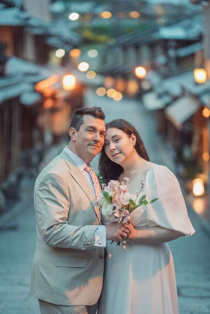 A romantic couple portrait on lantern-lit Ninen-zaka in Higashiyama Kyoto during an early morning Kyoto elopement and pre wedding photoshoot.