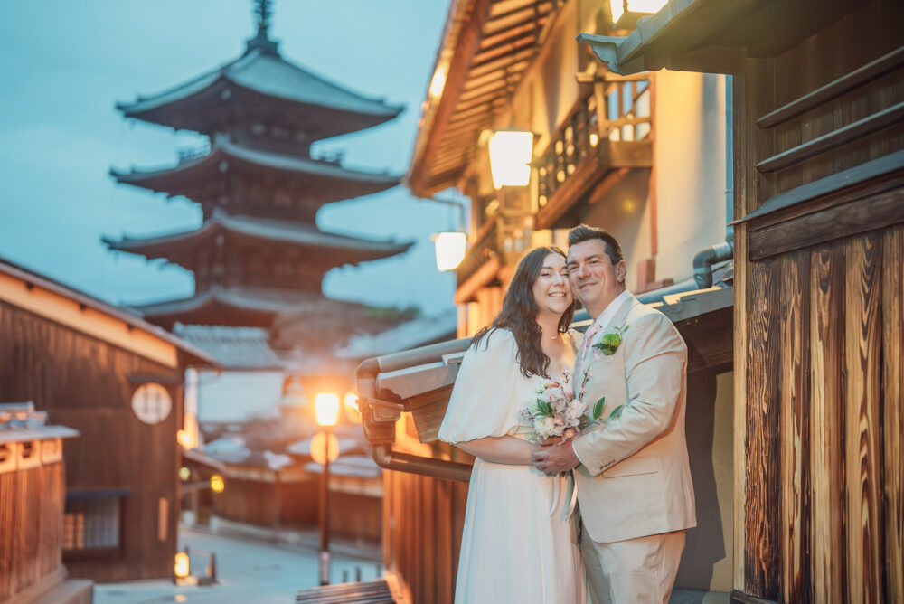 A couple walking through the quiet early morning streets of Higashiyama Kyoto with Yasaka Pagoda in the background during a pre wedding photoshoot.