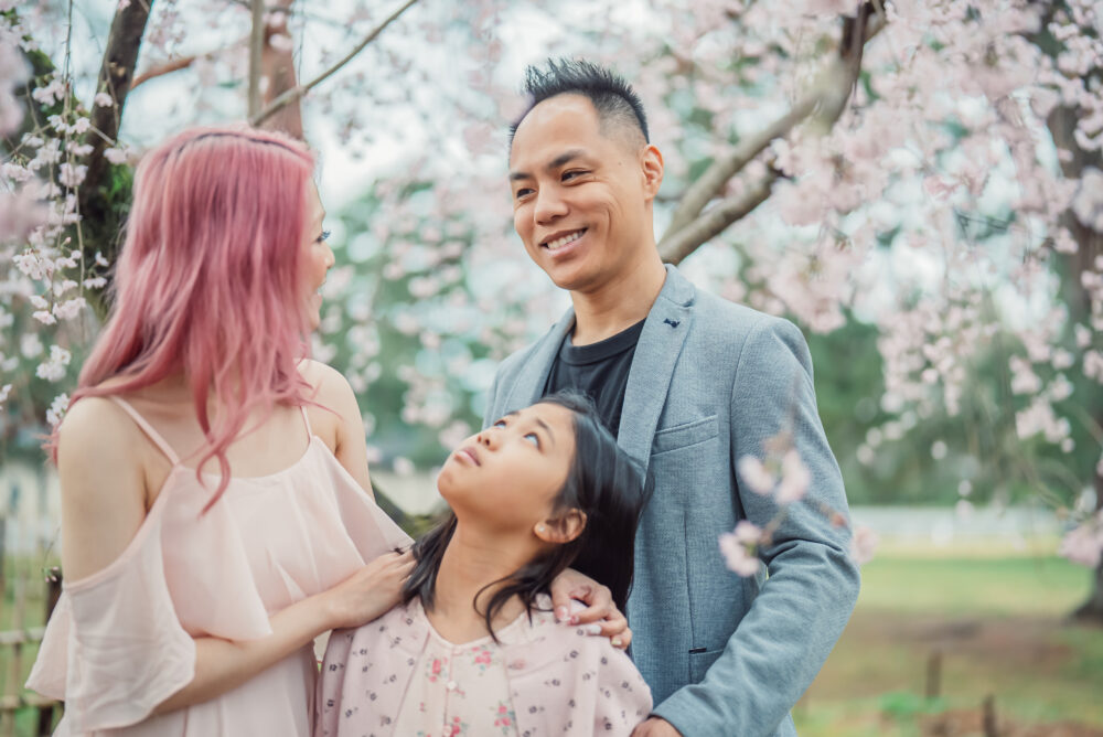 A father showing a heartfelt expression during a natural family photography session in Kyoto surrounded by traditional scenery
