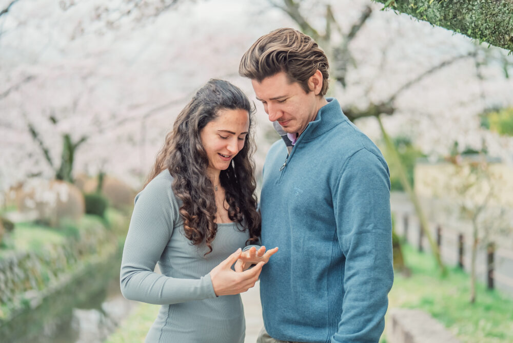 Couple Looking at Engagement Ring After Proposal on Philosopher’s Path in Kyoto