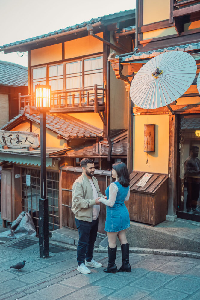 A couple sharing a romantic moment on Ninen-zaka in Higashiyama Kyoto during a sunrise engagement photoshoot.